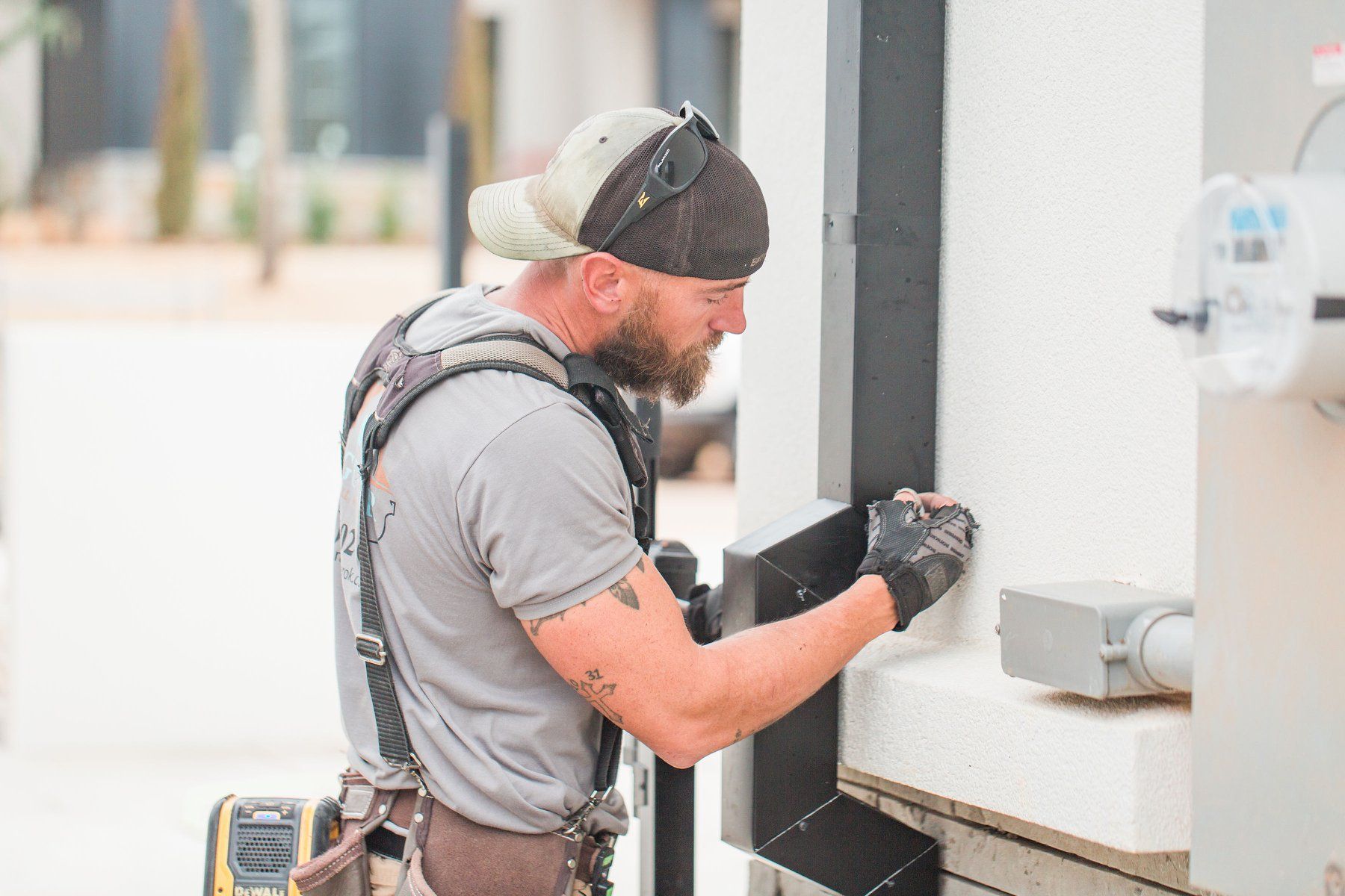 A man with a beard is working on a wall.