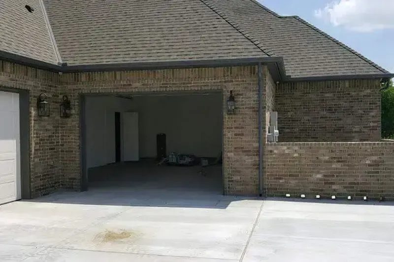 A brick house with a garage and a driveway.