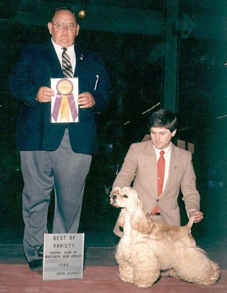 A man holding a ribbon stands next to a boy holding a sign that says best of winners