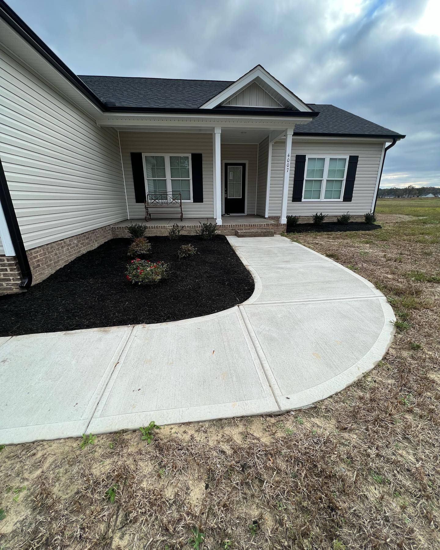 A White House With A Concrete Walkway — Youngsville, NC — Dontavius Landscaping