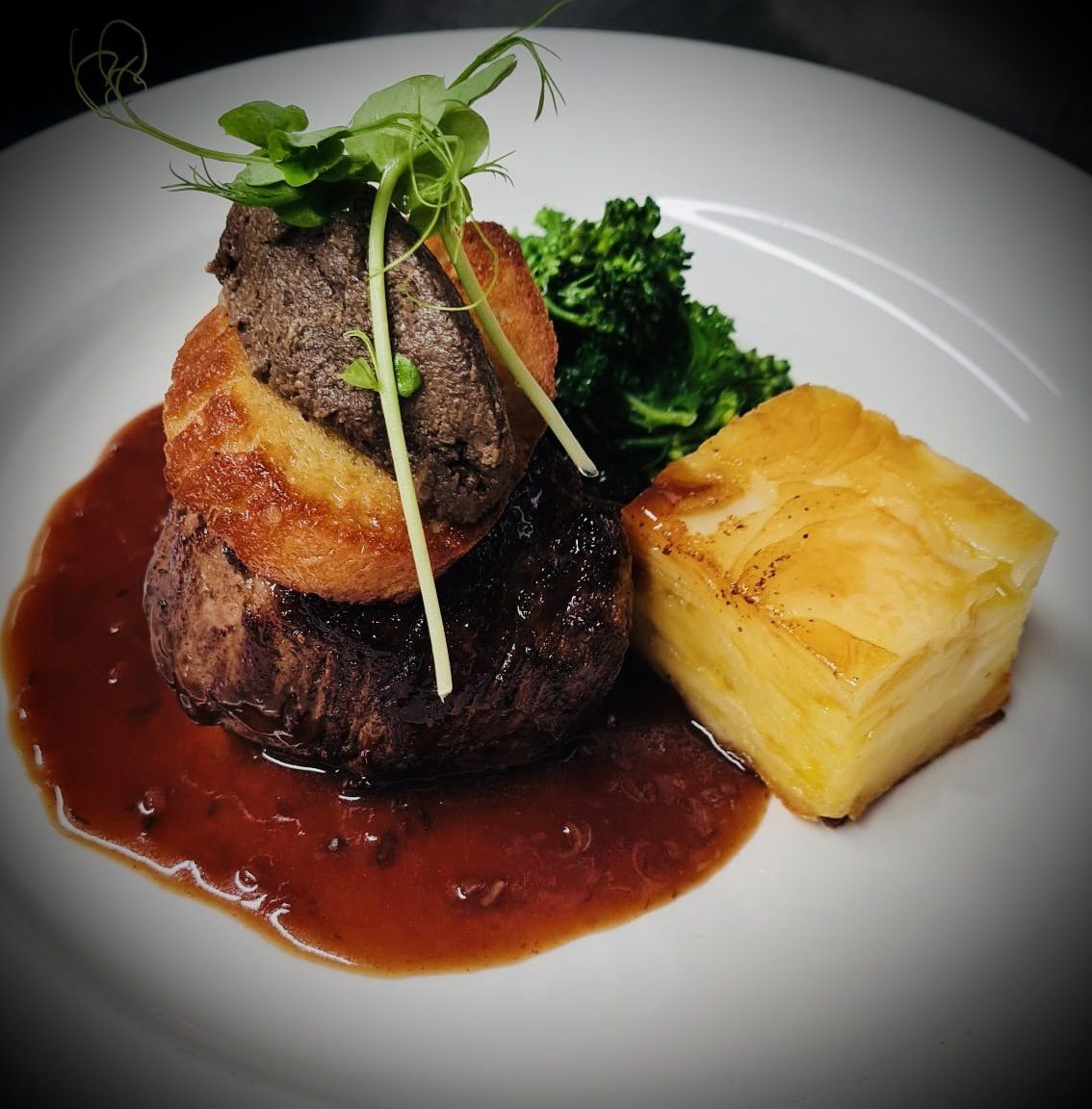 A close up of a plate of food with steak and potatoes