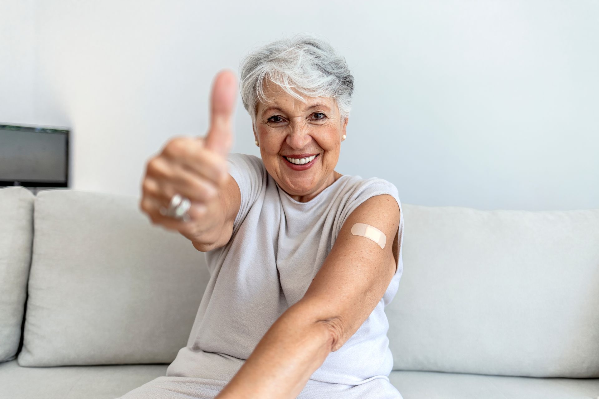 stock-photo-portrait-of-a-senior-woman-proudly-showing-her-arm-with-bandage-after-getting-vaccine-mature-white-2043907160-2880w