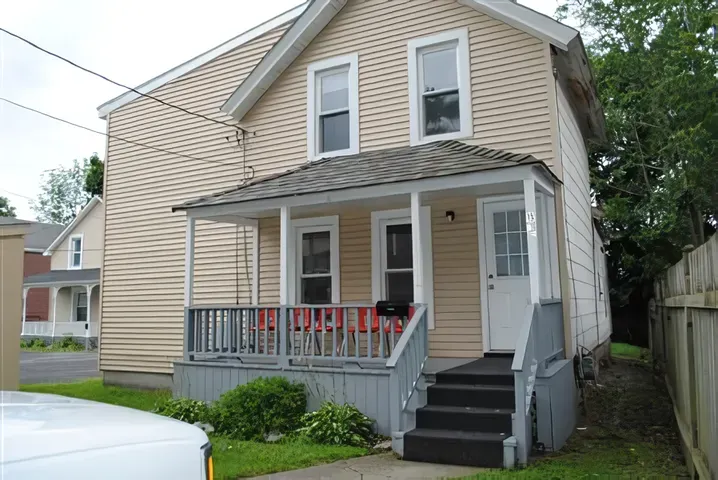 A small house with a porch and stairs