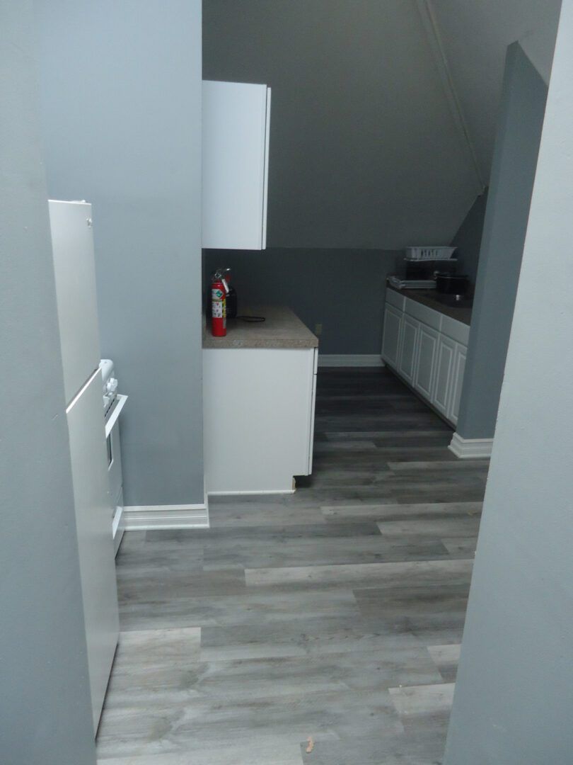 A kitchen with a fire extinguisher on the counter