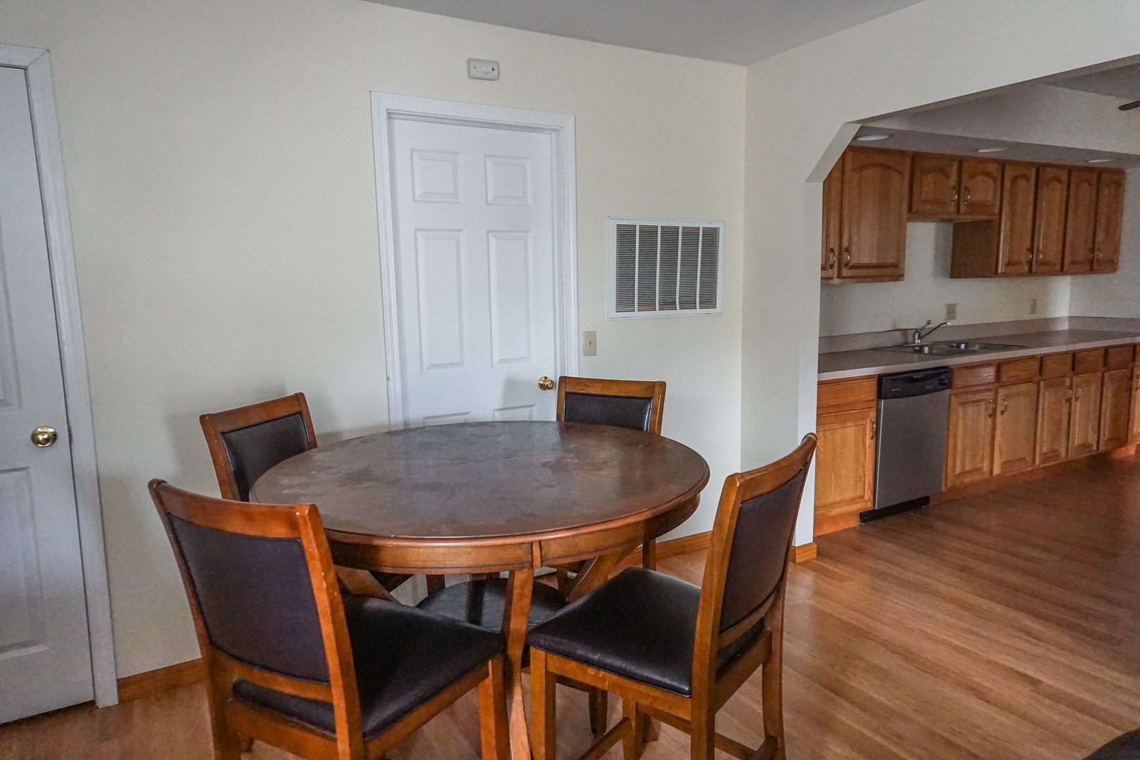 There is a table and chairs in the kitchen.