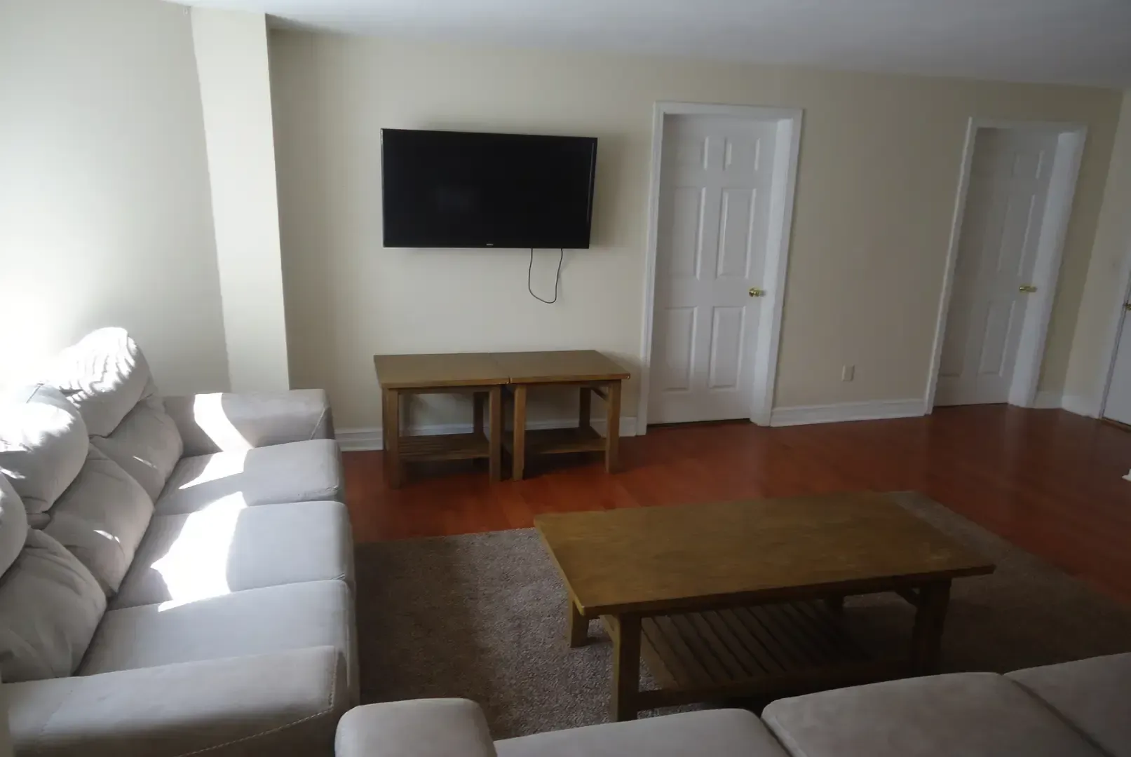 A living room with a couch and a flat screen tv