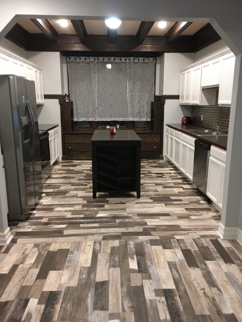 A kitchen with a large island in the middle