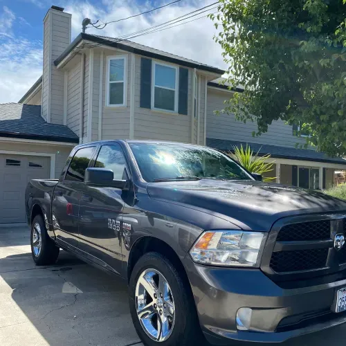 a ram truck is parked in front of a house .