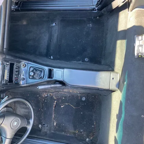 the inside of a car with a steering wheel and dashboard .