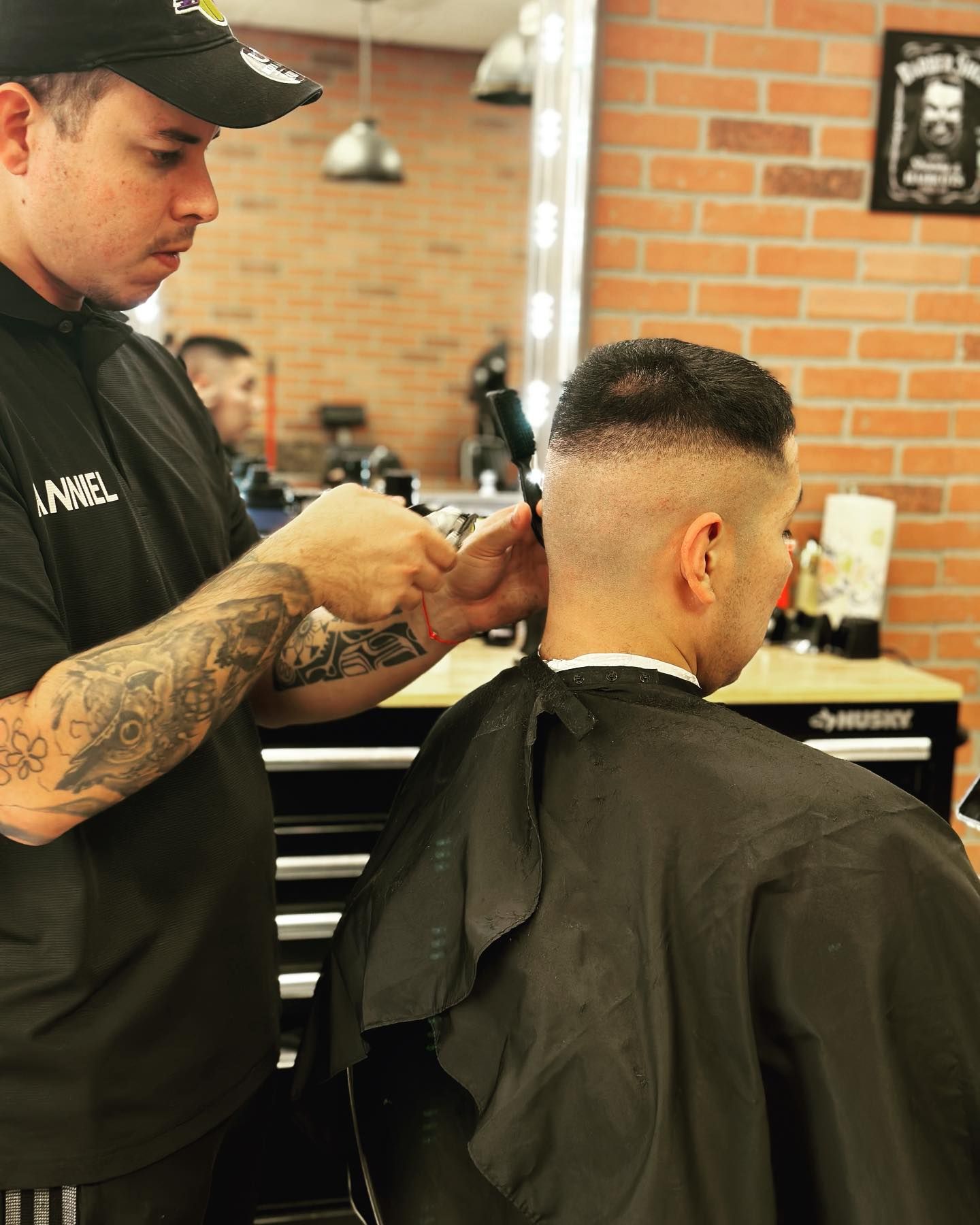A man is getting his hair cut by a barber in a barber shop.