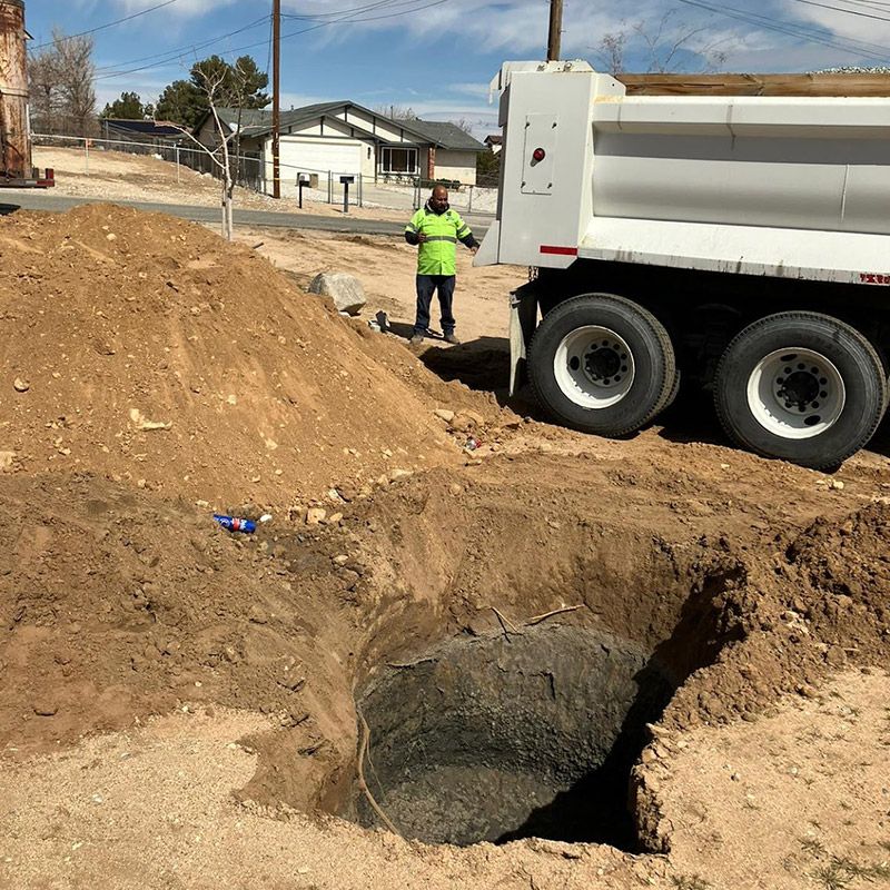 Man Next to a Dump Truck - Apple Valley, CA - Roto-Rooter Plumbers and Septic Service
