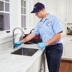 Man Working on a Kitchen Sink - Apple Valley, CA - Roto-Rooter Plumbers and Septic Service
