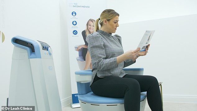 Woman sits on a medical device, reading a pamphlet in a clinic.