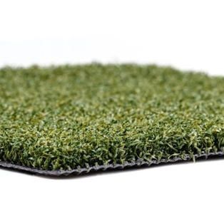 A close up of a piece of artificial grass on a white background.