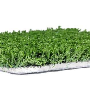 A close up of a piece of artificial grass on a white background.