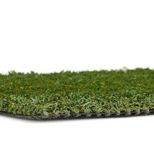 A close up of a piece of artificial grass on a white background.