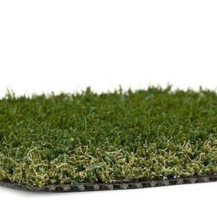A close up of a piece of artificial grass on a white background.
