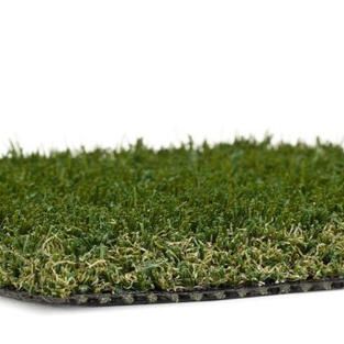 A close up of a piece of artificial grass on a white background.