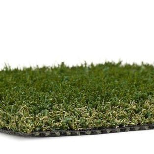 A close up of a piece of artificial grass on a white background.
