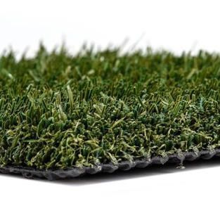 A close up of a piece of artificial grass on a white background.