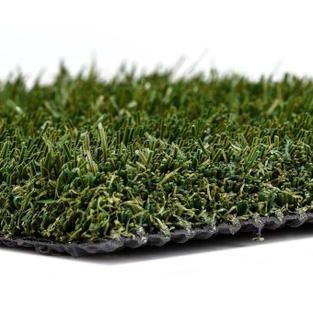 A close up of a piece of artificial grass on a white background.