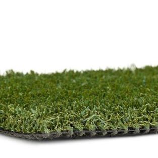 A close up of a piece of artificial grass on a white background.