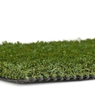 A close up of a piece of artificial grass on a white background.