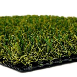 A close up of a piece of artificial grass on a white background.