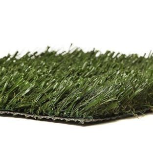 A close up of a piece of artificial grass on a white background.