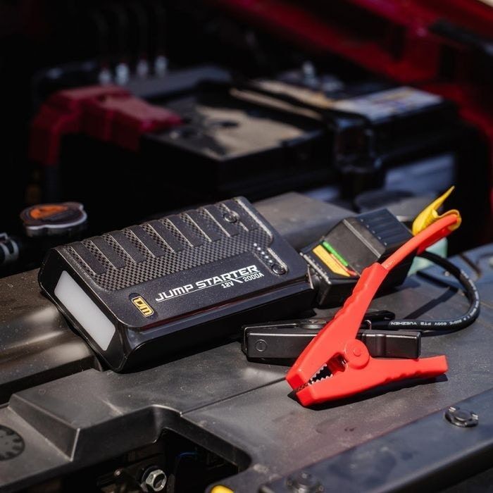 Black Car Jump Starter With Red Clamp, on the Engine of a Car — TJM Albury Pty Ltd in South Albury, NSW