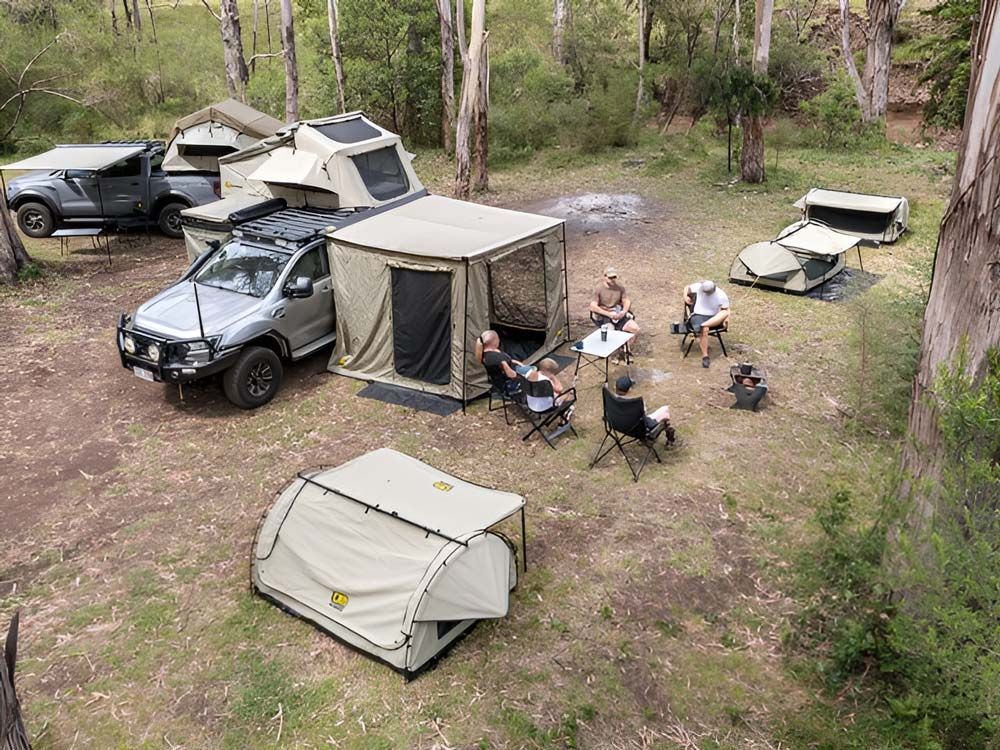 A Group of People Are Camping in a Field With Tents and Trucks — TJM Albury Pty Ltd in South Albury, NSW