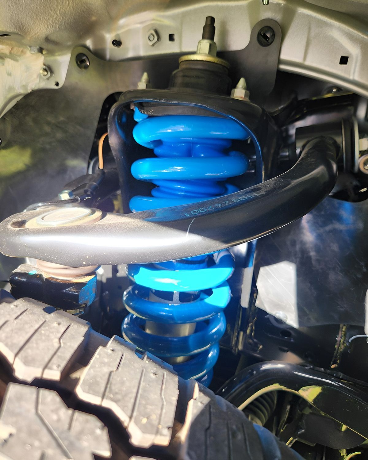 Blue Coil Spring Suspension On A Vehicle — TJM Albury Pty Ltd in South Albury, NSW
