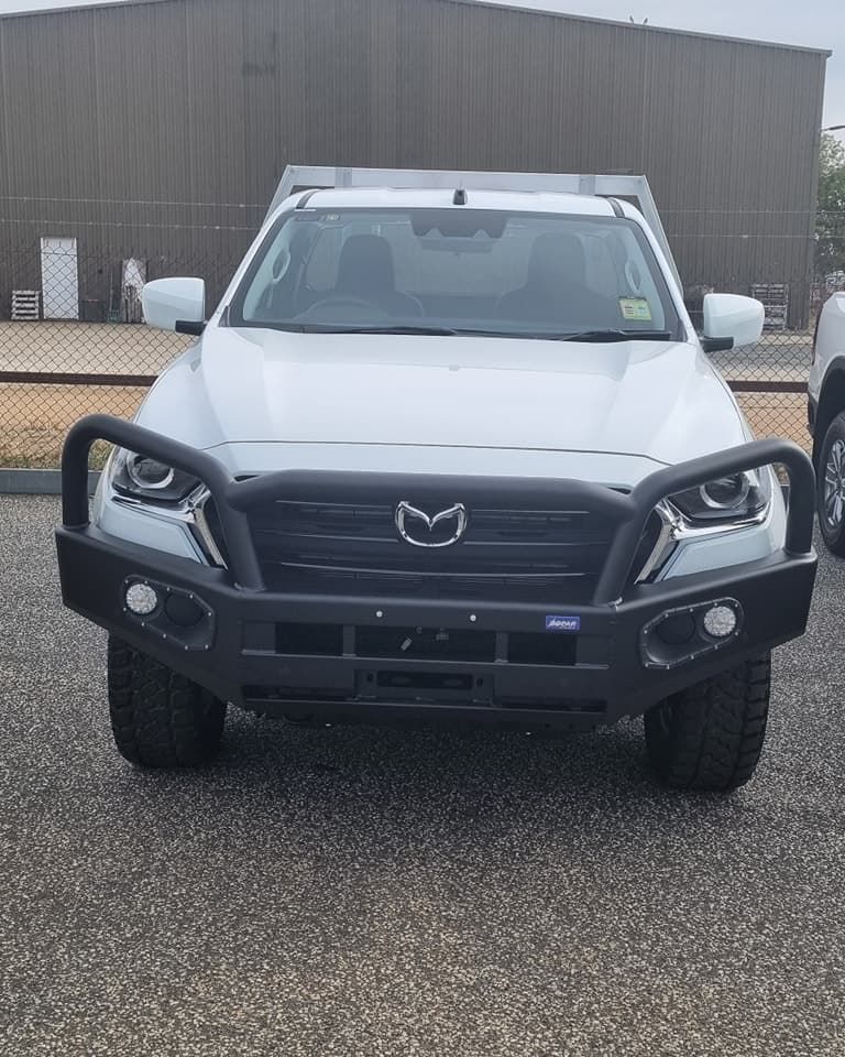 White Mazda BT-50 Flatbed Truck With Black Bull Bar, Parked Outside a Building — TJM Albury Pty Ltd in South Albury, NSW