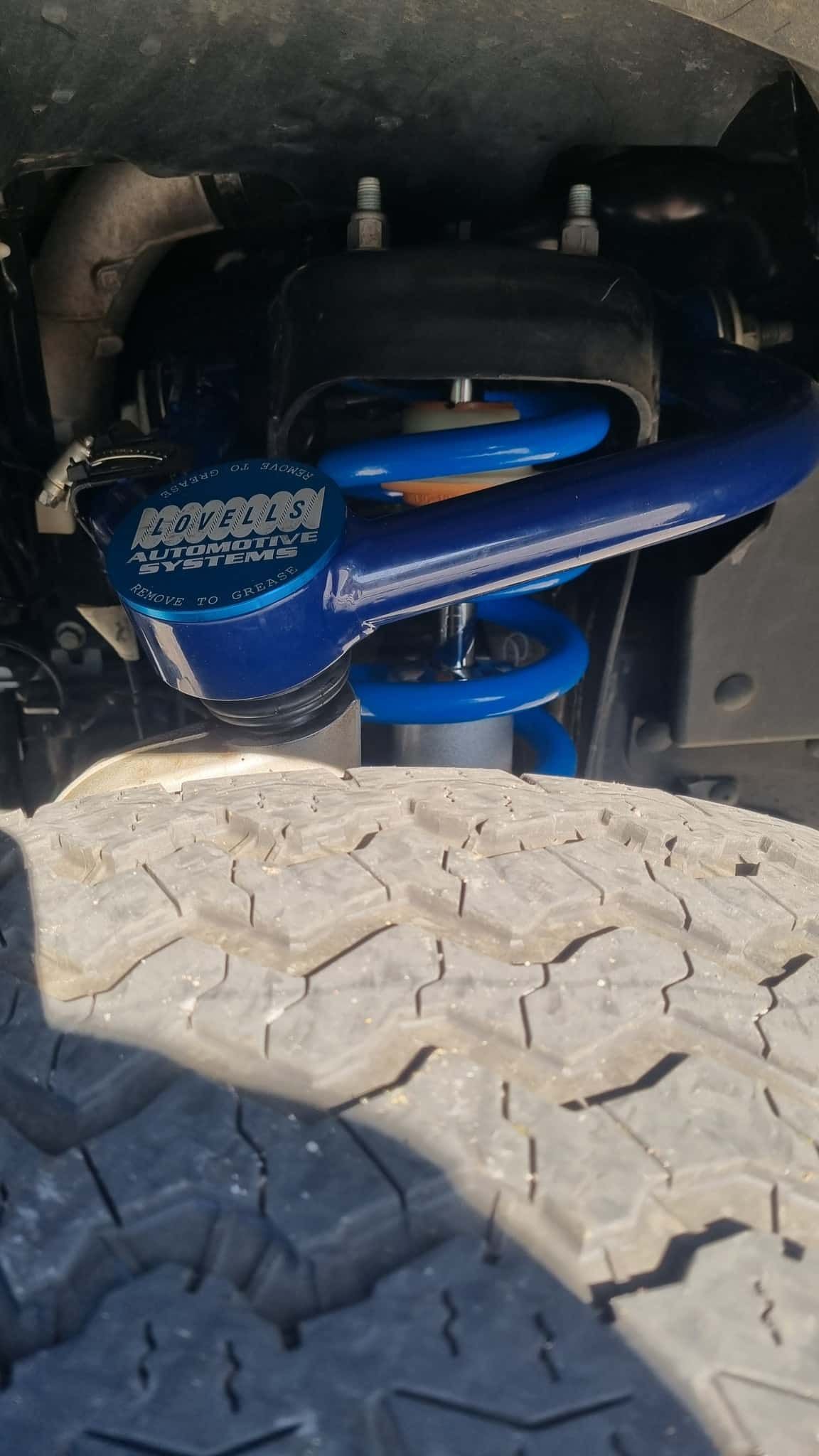 Blue Lifted Suspension System on a Vehicle, Viewed From Below — TJM Albury Pty Ltd in South Albury, NSW
