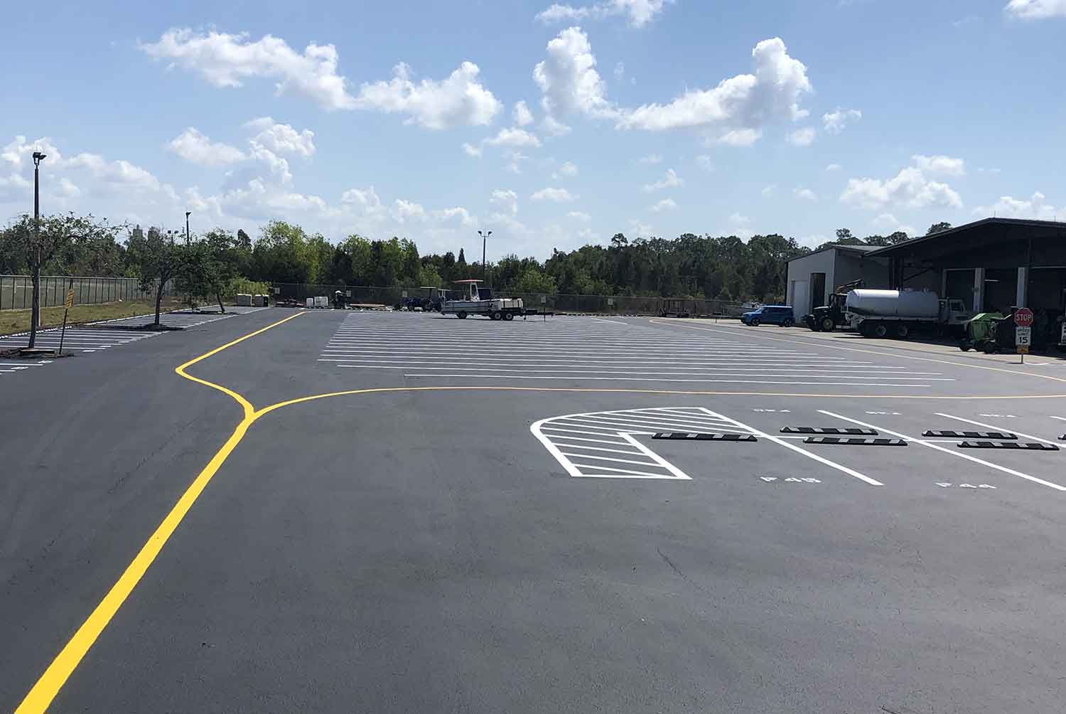 A parking lot with a yellow line on the side of the road.