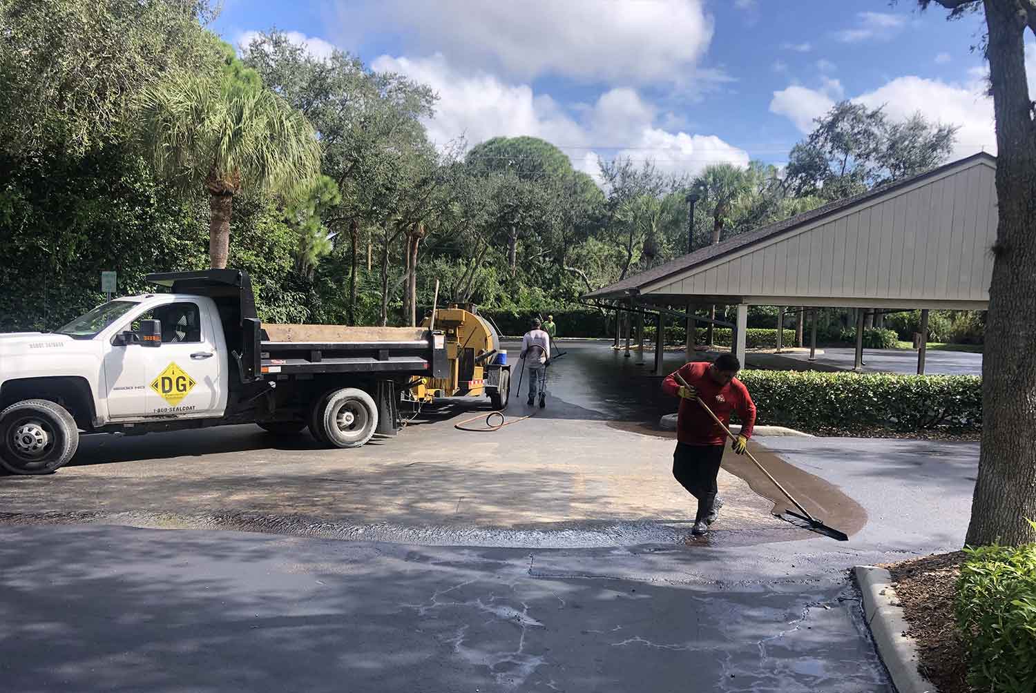 A man is walking down a street next to a truck.