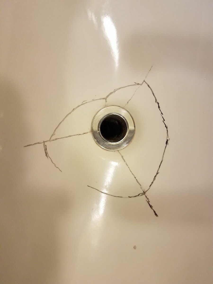 A sink with a hole in it that looks like a bird 's eye.