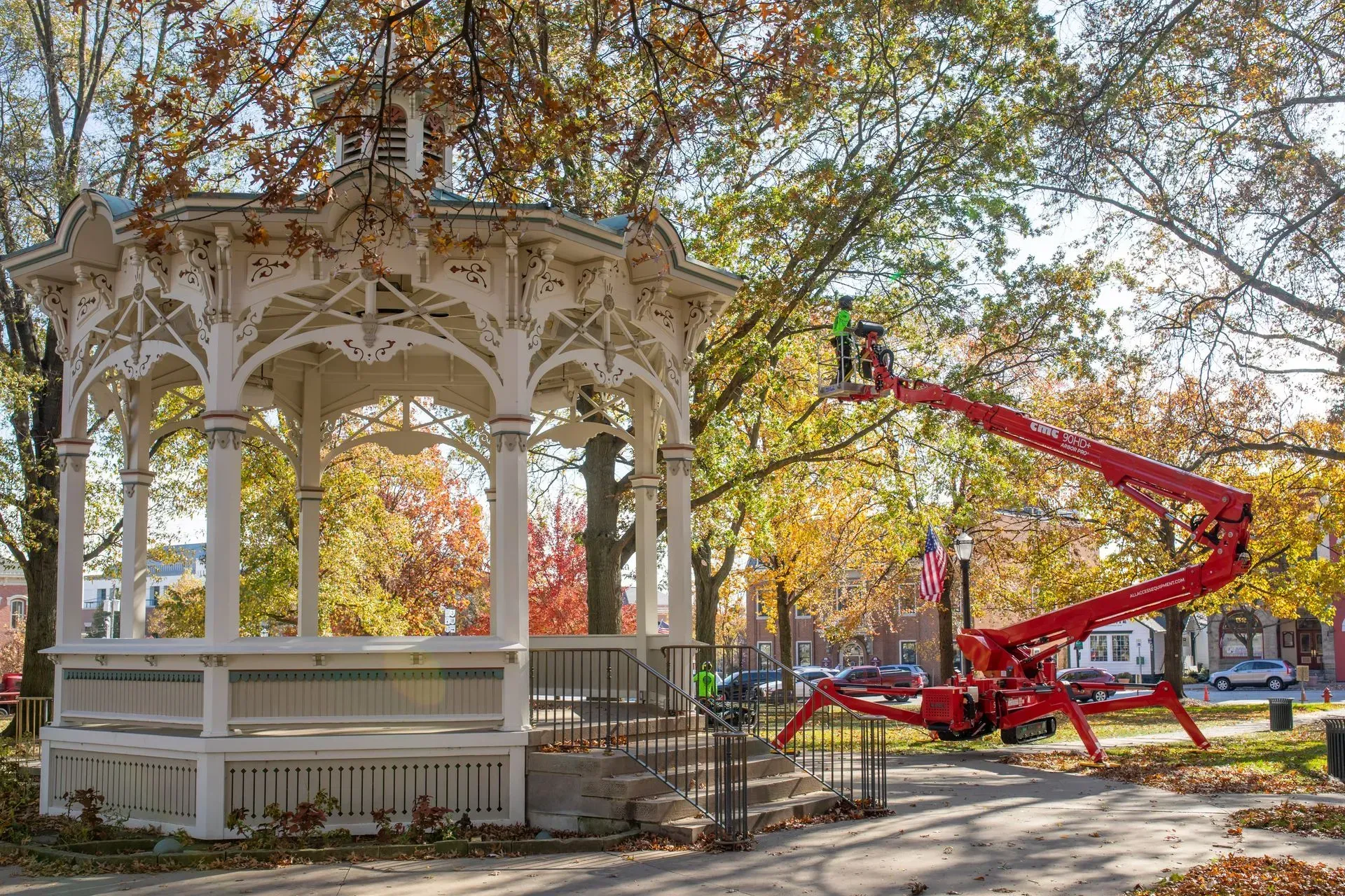 Red GMC dump truck with trailer parked on a road.