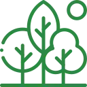 Tree service worker in a bucket truck pruning a tree near a house with a brown roof.