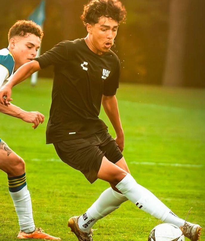 Ozark United Boys Academy player dribbling past a defender.