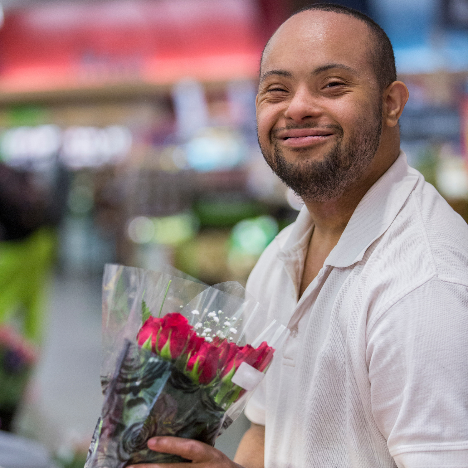 Man with disability carrying a bouquet of roses in his hand