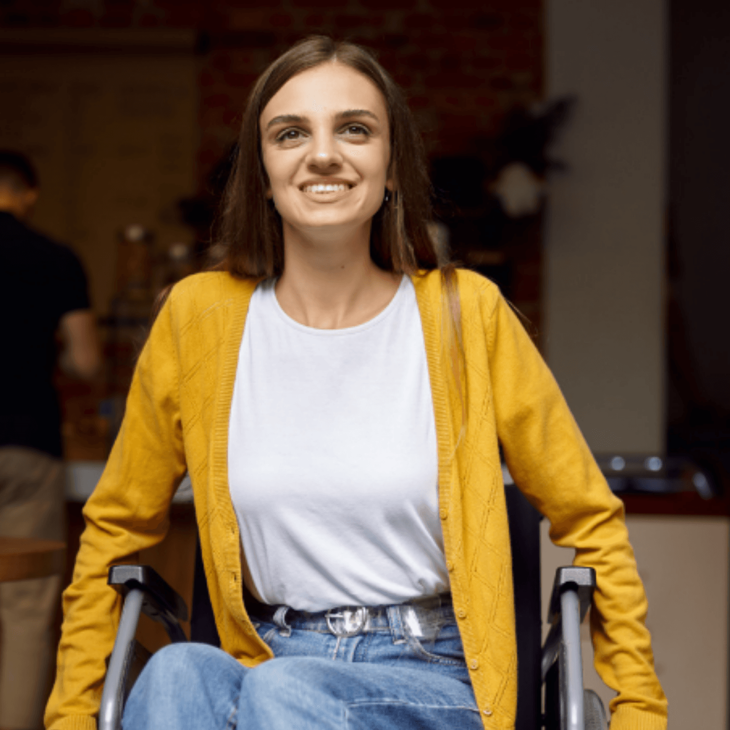 Woman with disability in a wheelchair looking beyond the camera, smiling