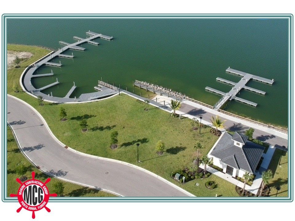 An aerial view of a marina with the letters mcc on the bottom - Punta Gorda, FL - Marine Contracting Group Inc