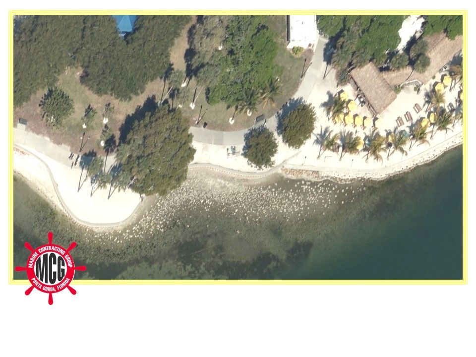 An aerial view of a beach with the letters mcc on the bottom - Punta Gorda, FL - Marine Contracting Group Inc