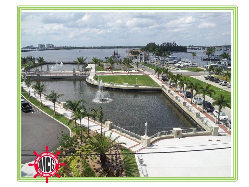 An aerial view of a city with a mcc logo in the corner - Punta Gorda, FL - Marine Contracting Group Inc