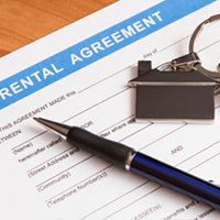 Rental agreement, pen, and a keychain