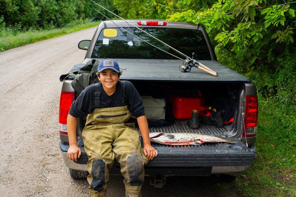 Young Fisherman With His Pick Up Truck — Ogden, UT — Sam T Evans Pickup Cover & Trailer Sales