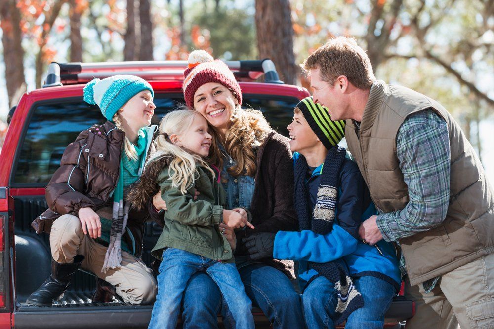 Happy Family With Their Pick Up Truck — Ogden, UT — Sam T Evans Pickup Cover & Trailer Sales