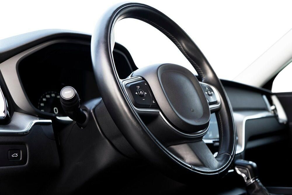 A Close Up of a Car Steering Wheel on a White Background — Precise Detailing Specialists in Emerald QLD