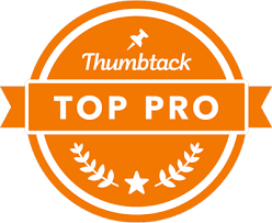 An orange thumbstuck top pro badge with a pin